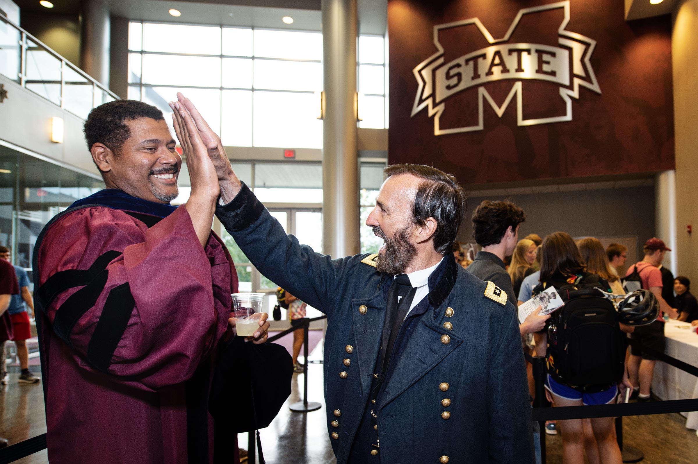 Ulysses S. Grant high-fives Professor Donald Shaffer following the Convocation ceremony in Humphrey Coliseum.
