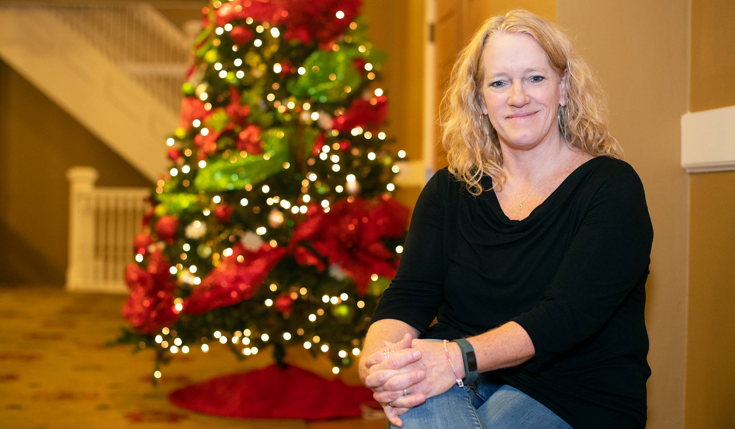 Lisa McReynolds, pictured in front a Christmas tree in Lee Hall.