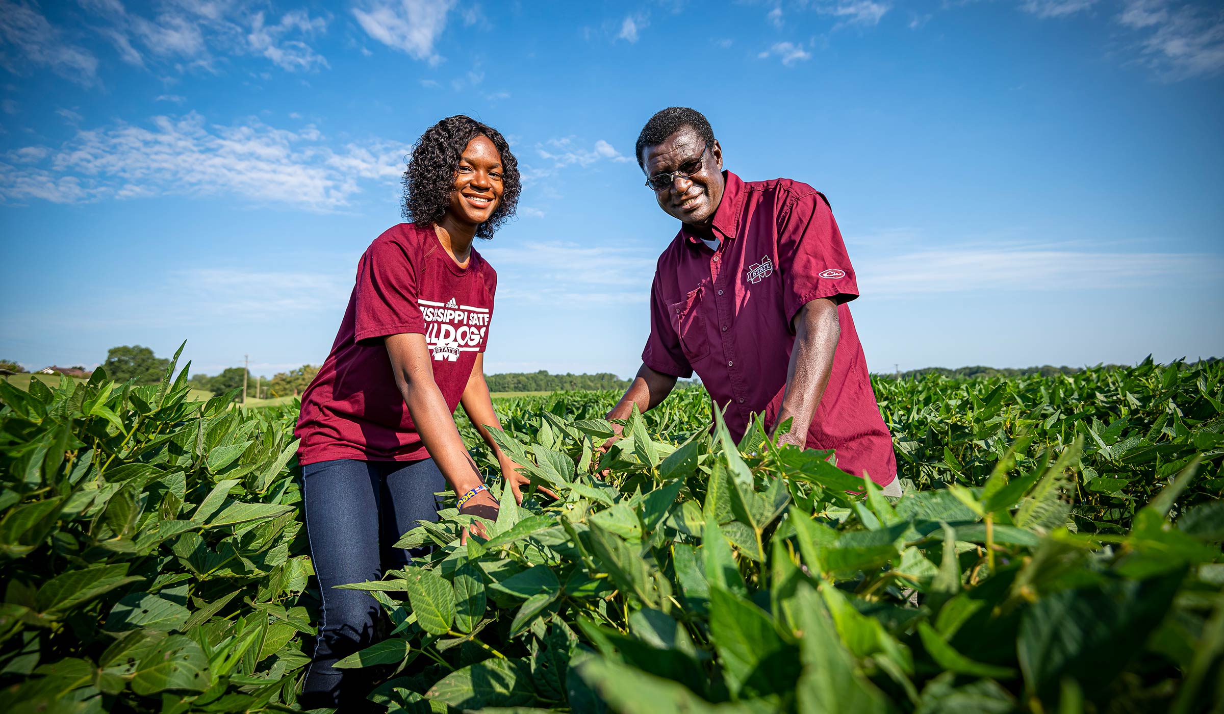 George Awuni and Urita Agana, pictured among a row of crops.