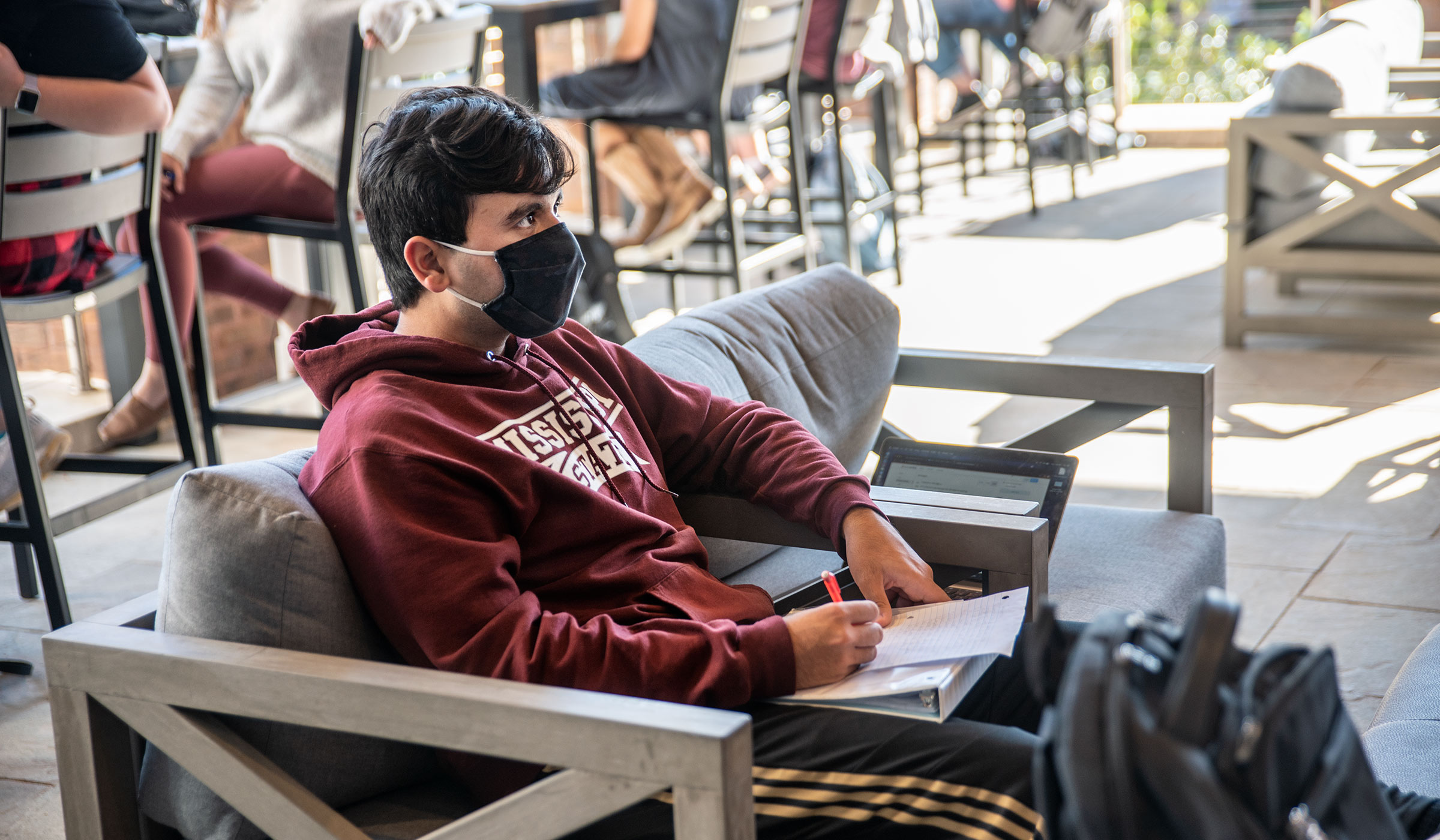 Software Engineering major Aaron Williams studies at one of the couches at Colvard Union&#039;s the recently covered porch space.
