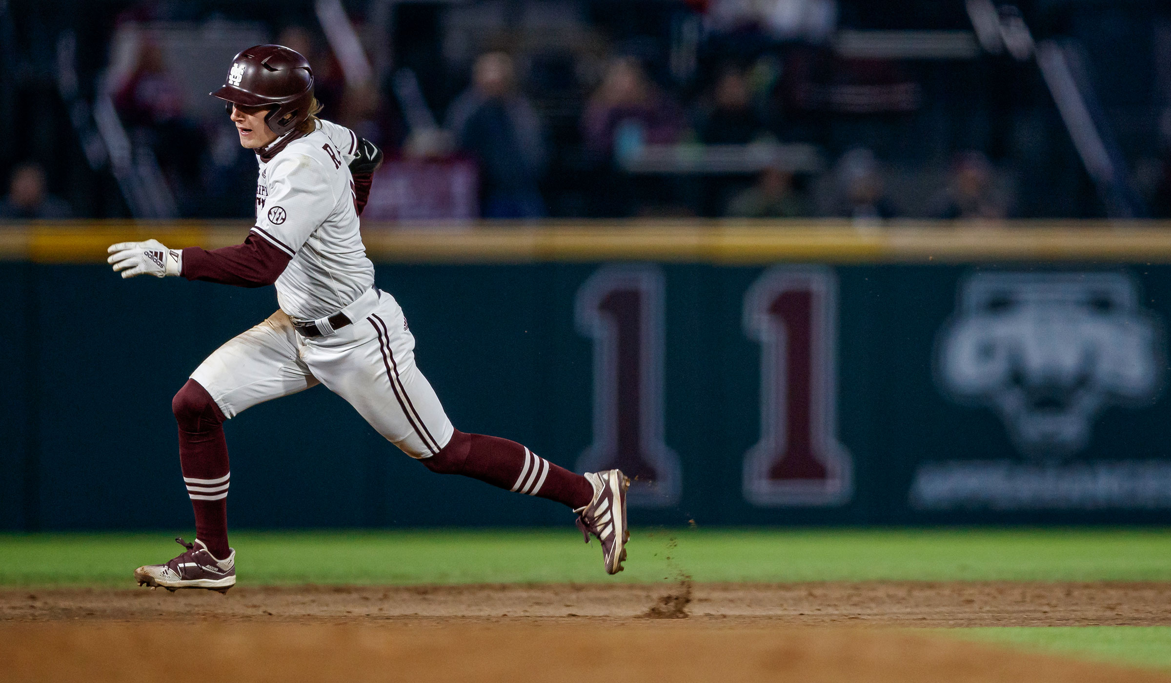 MSU Baseball player Rowdey Jordan kicks up dirt as hi runs past a base at Dudy Noble.