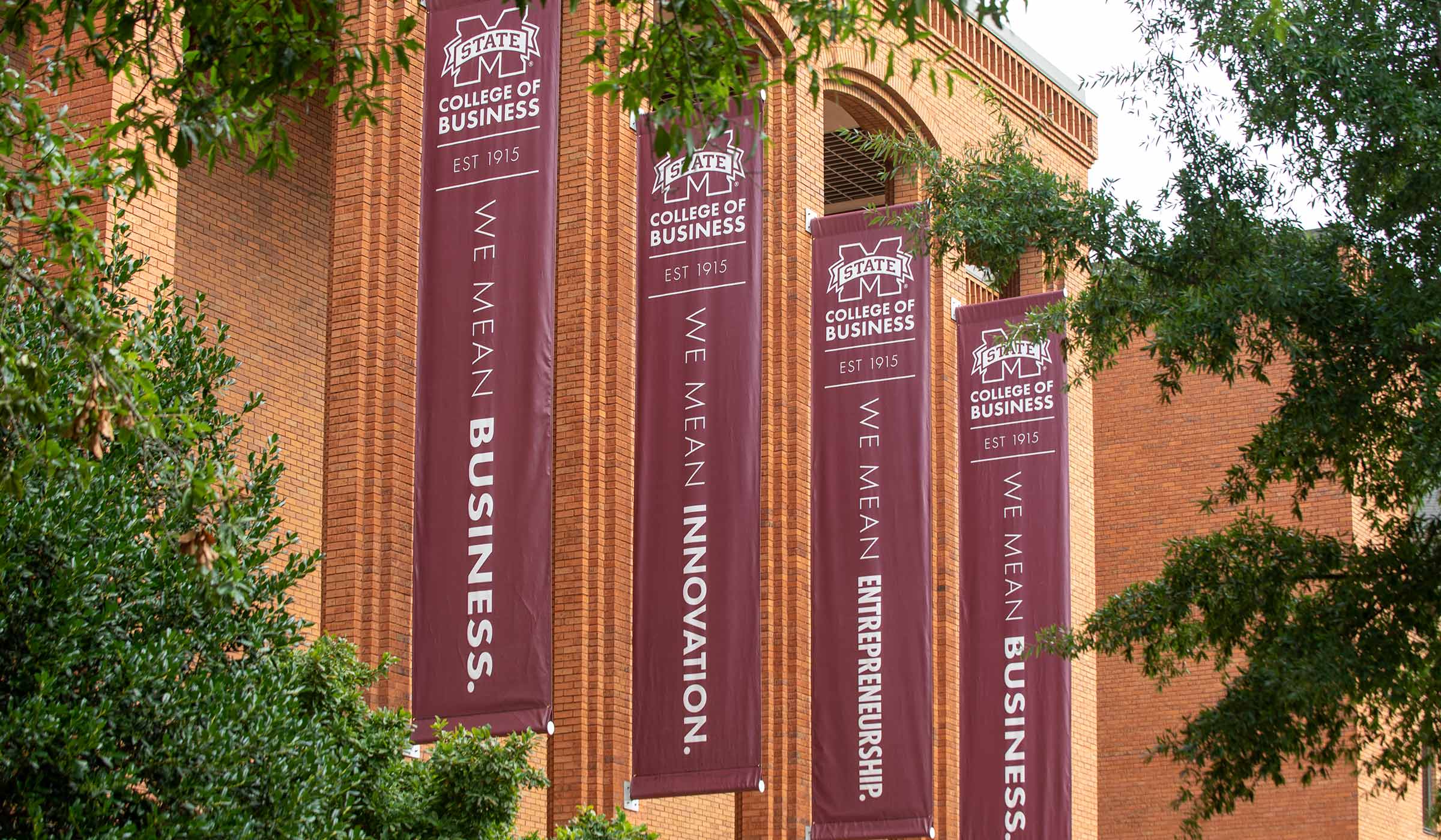 Maroon banners on brick columns