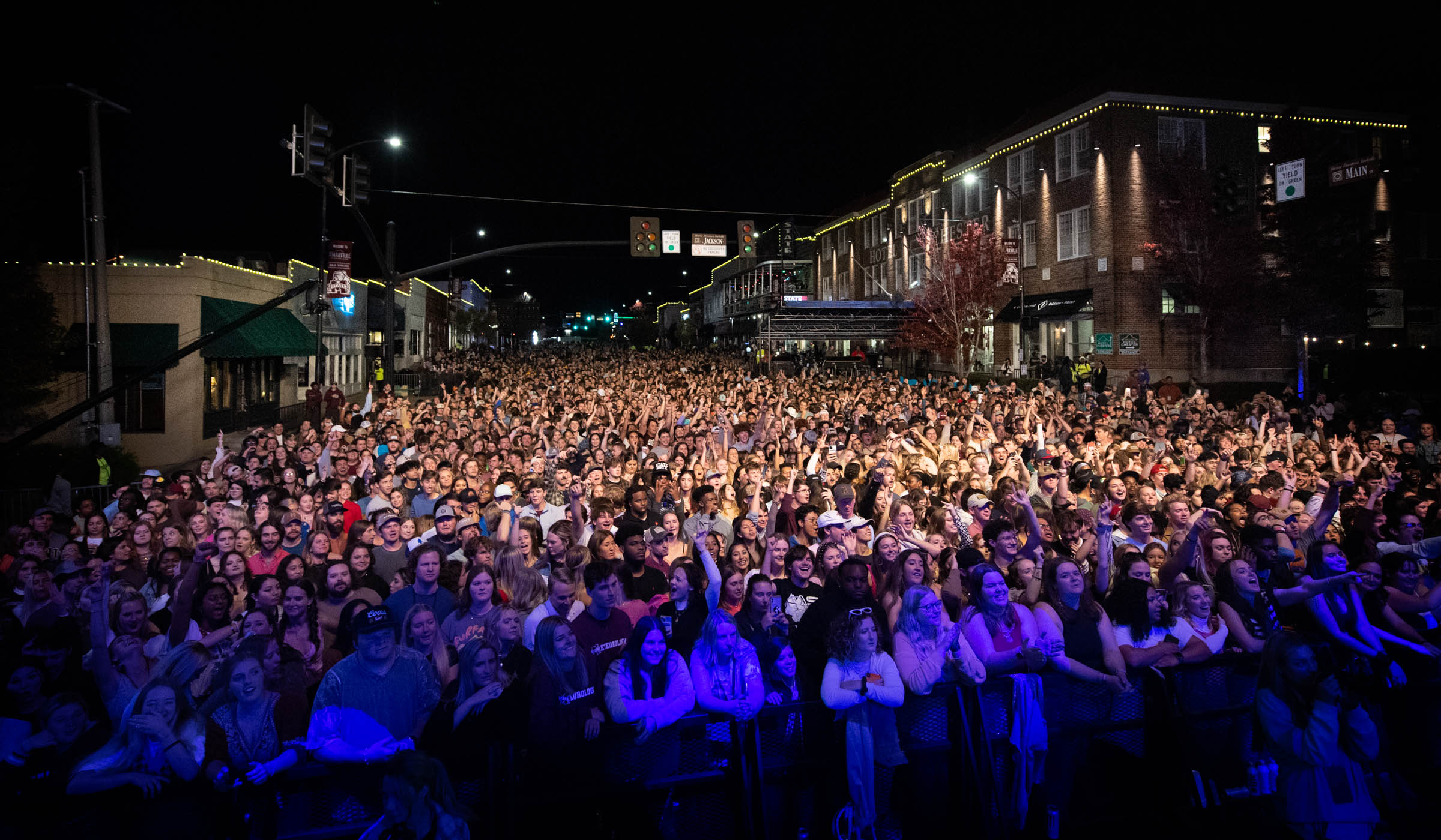Main Street Starkville is filled with a sea of fans faces, illuminated by the Bulldog Bash stage. 