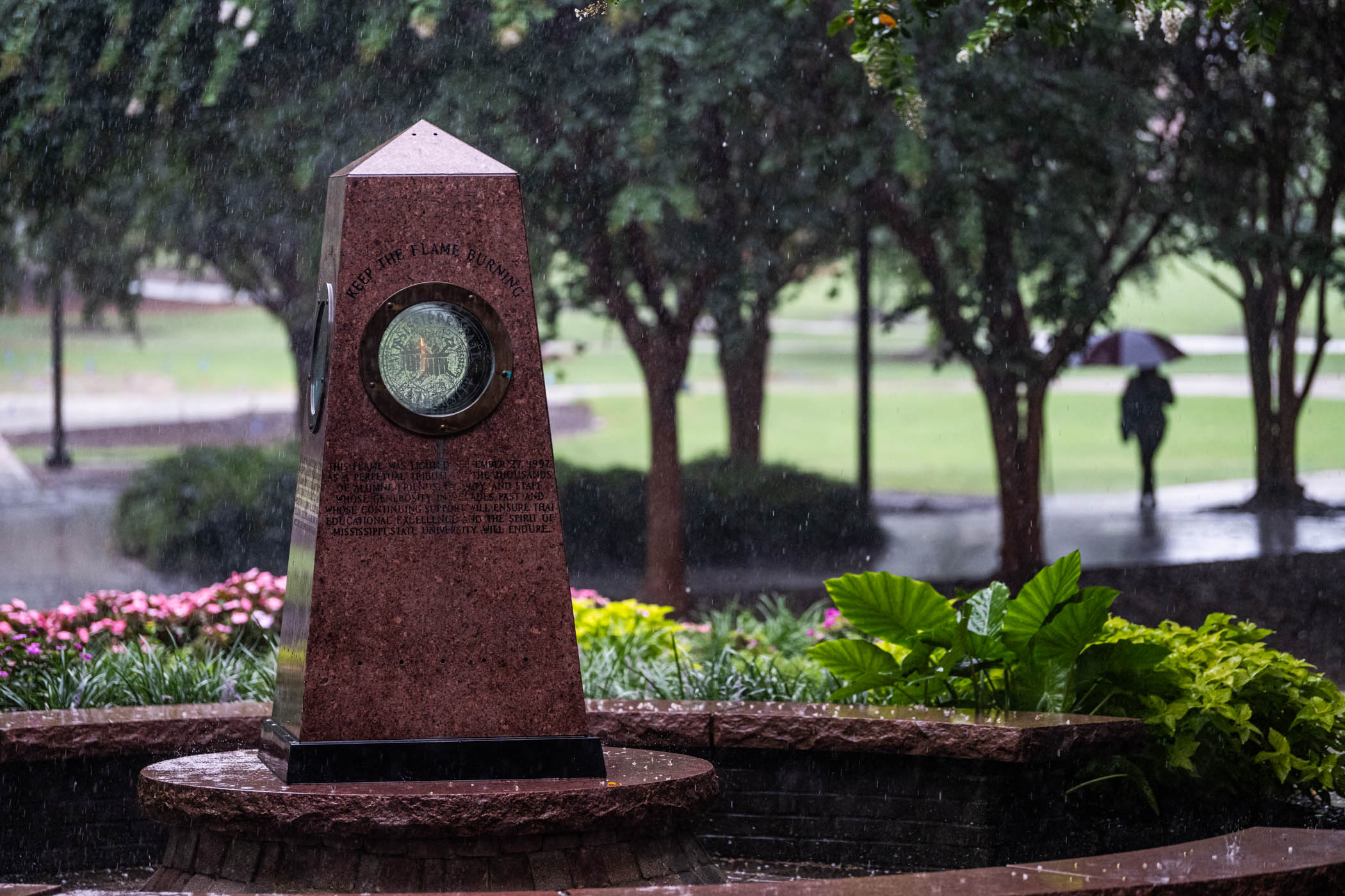 MSU&#039;s iconic Eternal Flame burns bright in the midst of a summer rainstorm. 