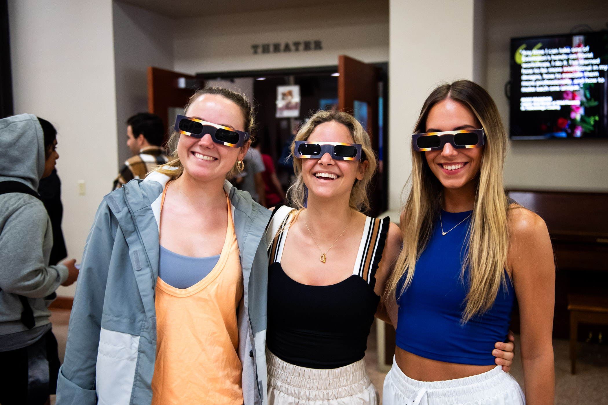 Claire Dillard (left,) Ella Hahs, (center,) and Elise Edwards (right,) sport their safety glasses at MSU&#039;s live viewing of the 2024 Great American Solar Eclipse inside Bost Theate