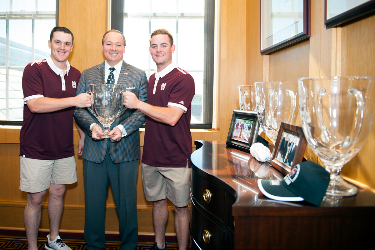 Baseball players present President Keenum with the Governor&amp;#039;s Trophy.