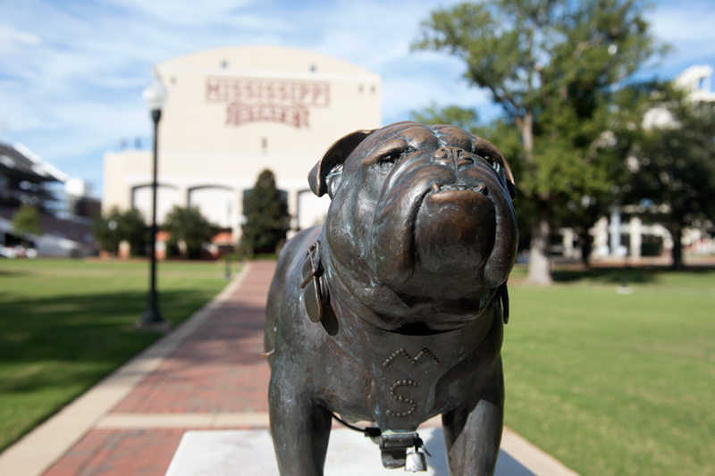 One of the Bully statues in the Junction with Davis Wade Stadium in the background