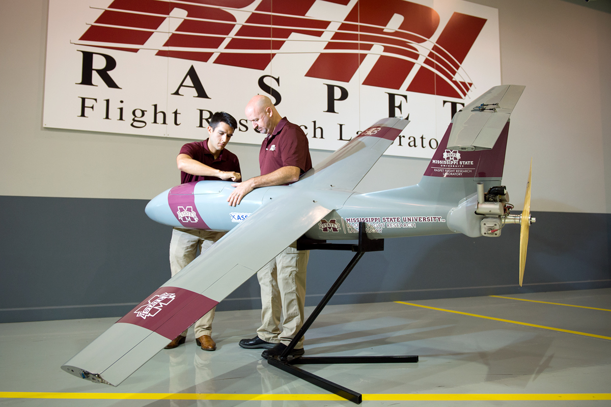 Raspet Flight Lab staff looks over the new UAV Outlaw-G2