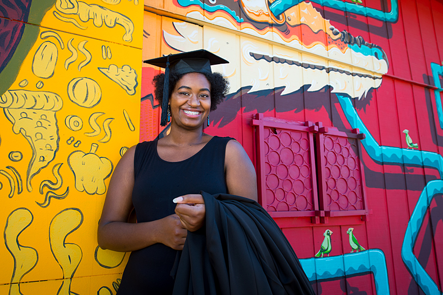 Anna Zollicoffer, pictured in front of a colorful mural.