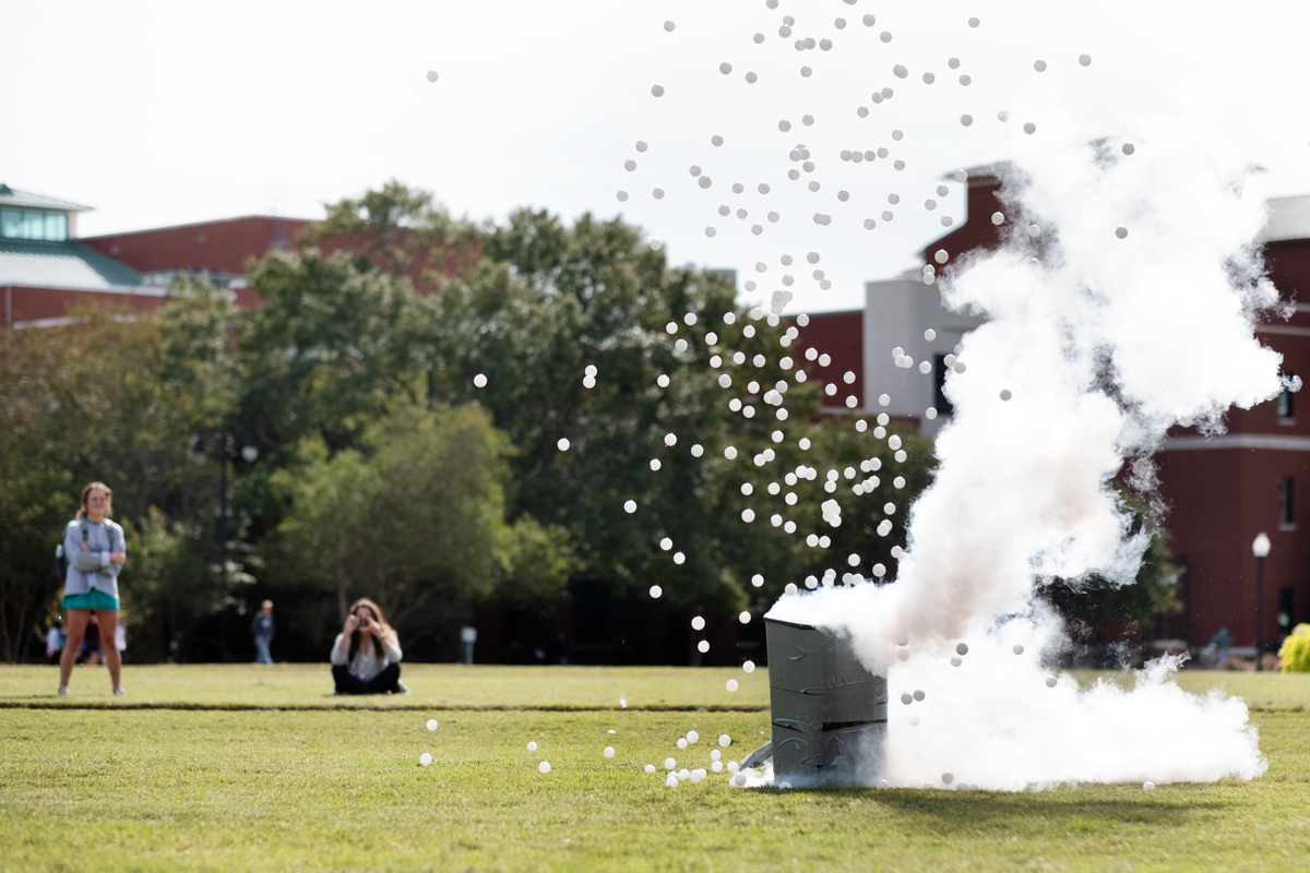 As part of ChemDawgs fun chemistry demos, Ping Pong balls and liquid nitrogen smoke explode from a trashan on the Drill Field.