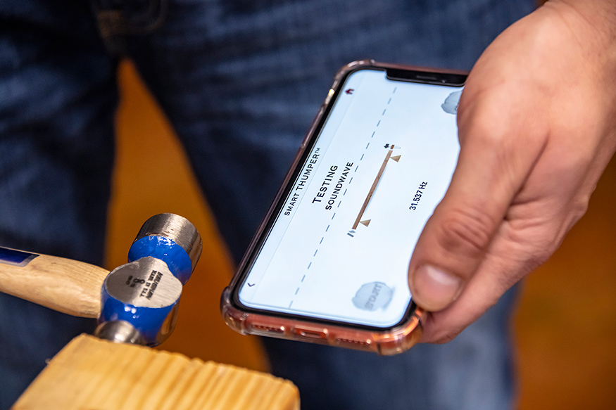 The “Smart Thumper” app, available for download in the Apple Store, uses soundwaves or vibrations to determine stiffness, a quality that relates to strength, for individual pieces of lumber. (Photo by David Ammon)