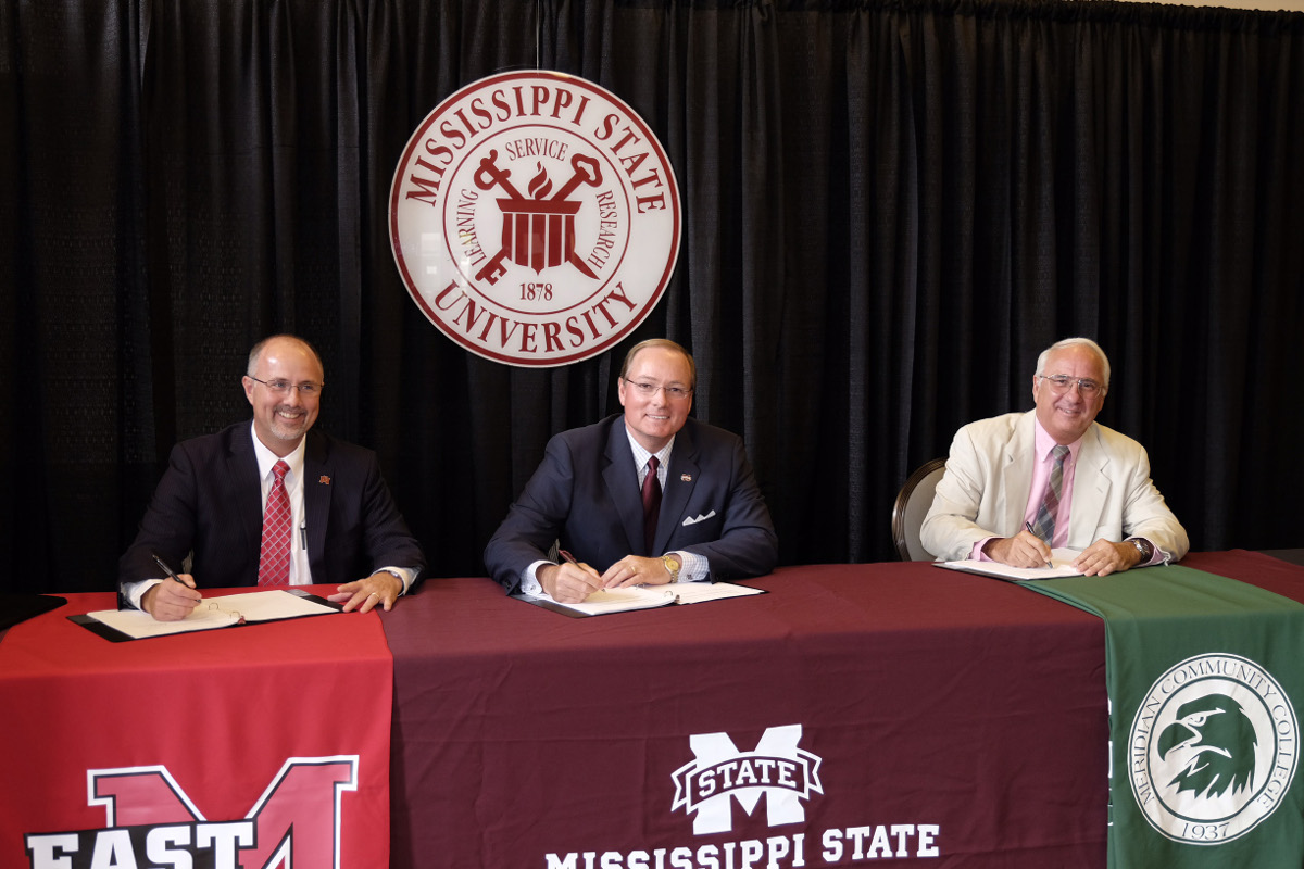 Mississippi State President Mark E. Keenum, center, joined East Mississippi Community College President Tom Huebner, left, and Meridian Community College President Scott Elliott today [July 15] in signing agreements that expand collaboration for nine baccalaureate degree programs. The partnerships give students pursuing an associate’s degree a more comprehensive, convenient bridge to a bachelor’s degree.   
