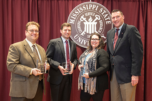 Jeff Davis, executive director of the MSU Alumni Association, far right, presents faculty and staff members with awards for outstanding teaching and mentorship of students throughout their academic careers. Recipients include, from left to right, Nicholas Fitzkee, associate professor of chemistry, the MSU Alumni Association’s Graduate Teaching Excellence Award; Peter Summerlin, assistant professor of landscape architecture, the Alumni Association’s Early Career Undergraduate Teaching Excellence Award; and Stacy Haynes, associate professor of sociology, the Alumni Association’s Outstanding Graduate Student Mentor Award. (Photo by Megan Bean)