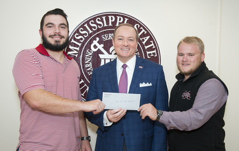 President Mark E. Keenum, center, presents a $1,000 check to Mississippi State Bass Fishing Club members Jack Stegall, left, and Caleb Hebert for the duo’s second-place finish in last month’s YETI FLW College Fishing Southeastern Conference bass tournament on Lake Seminole in Georgia. With their accomplishment, Stegall and Hebert qualify to represent Mississippi State in the 2018 YETI FLW College Fishing National Championship. (Photo by Russ Houston)