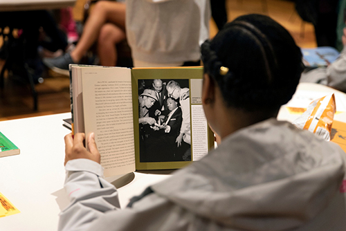 A student reads a book in the John Grisham Room during a National African American Author Read-In event at MSU’s Mitchell Memorial Library.