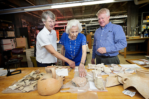 From left, independent scholar and visiting researcher Marylinda Govaars, looks over artifacts from the E. Jerry Vardaman collection from Machaerus—an ancient site where John the Baptist was martyred—along with Alfalene Vardaman Morse, the late professor’s wife who accompanied him to the site, and James W. “Jimmy” Hardin, associate professor and interim director of MSU’s Cobb Institute of Archaeology. (Photo by Megan Bean) 