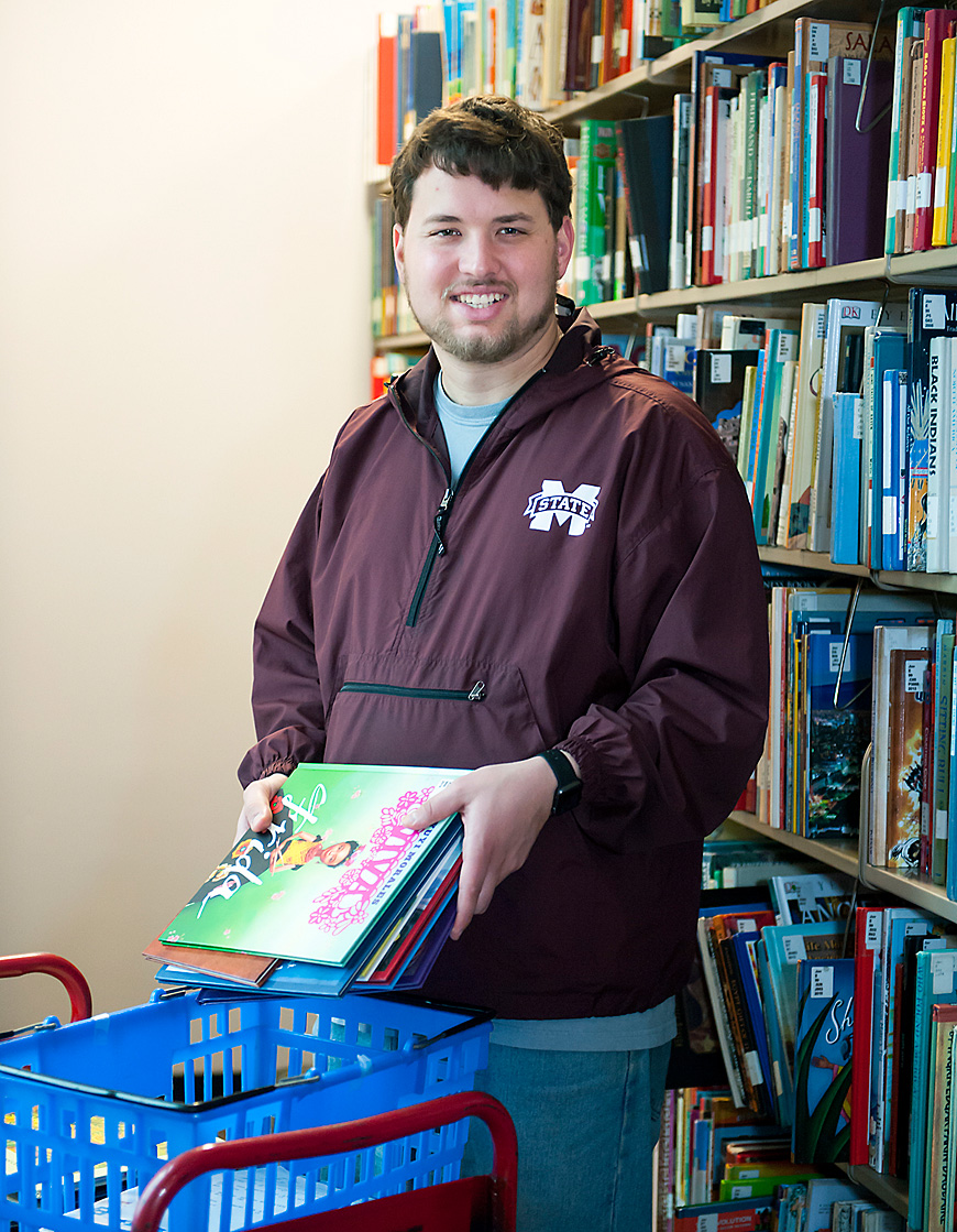 Daniel Mooney from Brookhaven, a senior in the ACCESS Program at Mississippi State, works in a support role at Mitchell Memorial Library. ACCESS helps students with intellectual disabilities gain independent living and employment skills. (Photo by Russ Houston)
