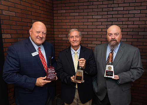 Bruce Thomas, Charles Wax and Michael Brown hold special cowbells commemorating the new fellowship in MSU’s Department of Geosciences. 