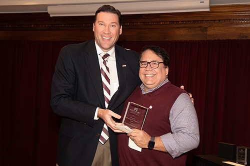 MSU Alumni Association Executive Director Jeff Davis congratulates Michael Breazeale, recipient of the MSU Alumni Association’s Early Career Undergraduate Teaching Excellence Award. (Photo by Beth Wynn)