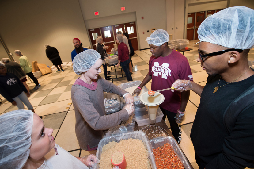 MSU students work to pack 10,000 meals as part of the Stop Hunger Now initiative Friday [Oct.21] at MSU. Pictured, from left to right, are freshman interior design major Meghan Moore of Marietta, Georgia; freshman kinesiology major and Litchfield, Illinois, native Abby Shelton; freshman biochemistry major Quantez Perkins, a Jackson native; and freshman computer science major Sidney Brown, also from Jackson. (Photo by Megan Bean)