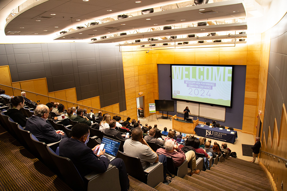 A picture of an auditorium full for a conference