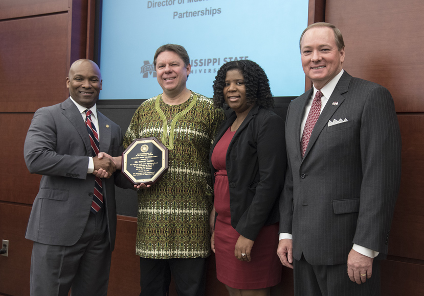IHL Trustee Shane Hooper presents a 2017 Diversity Award to MSU Professor of Music Robert Damm as MSU Interim Assistant Vice President of Multicultural Affairs Ra’Sheda Forbes and MSU President Mark E. Keenum look on. (Photo by Jay Ferchaud/ University of Mississippi Medical Center)
