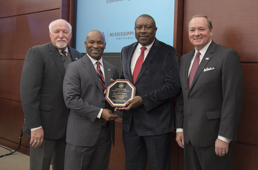 MSU Agriculture and Natural Resources Extension Agent Harvin Hudson receives a 2017 Diversity Award from IHL Trustee Shane Hooper (second from left), MSU President Mark E. Keenum (far right) and MSU Associate Vice President for Agriculture, Forestry and Veterinary Medicine Bill Herndon. (Photo by Jay Ferchaud/ University of Mississippi Medical Center)