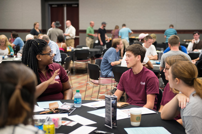 Maroon Volunteer Center Graduate Assistant Alexis Hampton, a graduate student studying student affairs, speaks with MSU sophomore and Hillel President Jacob Craig during the 2016 Interfaith Dialogue at MSU. (Photo by Megan Bean)