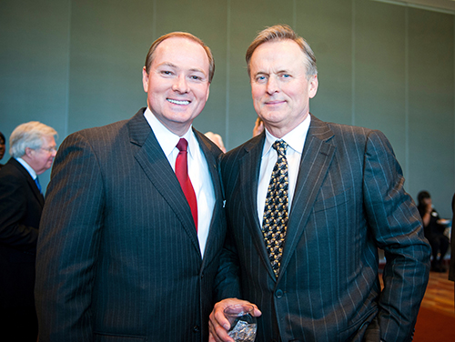 MSU President Mark E. Keenum, left, and best-selling author John Grisham are pictured at an MSU event in 2013. Grisham will return to campus in August to give the keynote address for the university’s Fall Convocation. (Photo by Russ Houston)