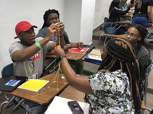 Students in the AP physics summer preparatory academy conducted by Mississippi State and the Global Teaching Project build a spaghetti tower during a lesson. Students in the two-week program achieved dramatic gains in their understanding of physics. (Global Teaching Project)