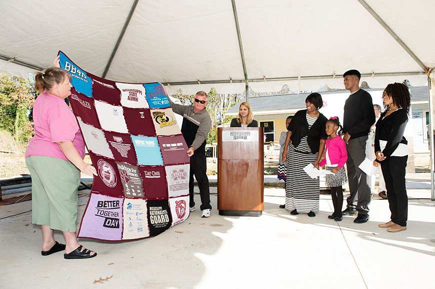 Starkville Area Habitat for Humanity volunteers presented the Shalisha Owens family with a quilt at the dedication for their new home Thursday [Dec. 17] at 104 Owens St. Dot Livingston annually makes the quilt. Shalisha is a single mother of four, includi