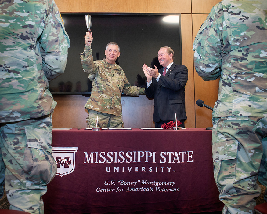 Maj. Gen. Janson D. “Durr” Boyles, Adjutant General of Mississippi, and Mississippi State University President Mark E. Keenum celebrate after signing a memorandum of agreement between MSU and the Mississippi National Guard to establish the Bulldog Free Tuition Program. The new program ensures free tuition for eligible Mississippi National Guard service members enrolled full-time at MSU. (Photo by Megan Bean)