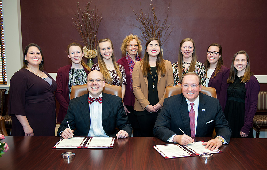 Starkville Mayor Parker Wiseman and Mississippi State President Mark E. Keenum (seated, left and right) sign a proclamation announcing local observances of National Nutrition Month. The university’s Student Dietetic Association is organizing several activities during March. SDA members at the signing ceremony included (standing front, from left) Danielle Mosley, Kayleigh Hynes, Alesa Taylor, Mary Hellen Makamson, Courtney Galistel, Sarah Kelly, and Haley Wheeler. Also pictured (at rear) is instructor Renee Matich, who represented SDA adviser Sylvia Byrd. (Photo by Russ Houston)