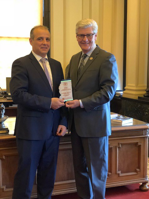 Mississippi Gov. Phil Bryant, right, presents the Excellence in Local and District Government Award to Domenico “Mimmo” Parisi, executive director of Mississippi State’s National Strategic Planning and Analysis Research Center. (Submitted photo)
