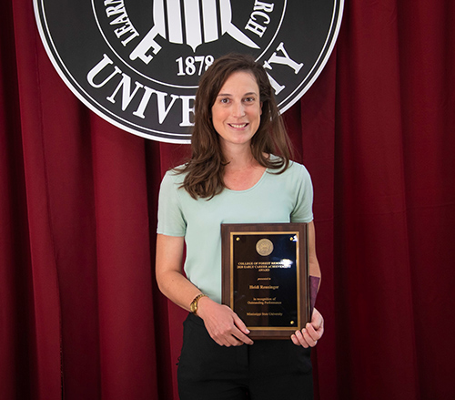 Heidi Renninger holding the CFR/FWRC Early Career Achievement Award