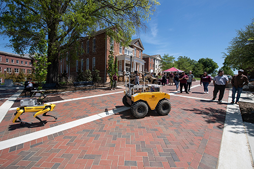 Robots move across the YMCA Plaza during the 2023 research showcase