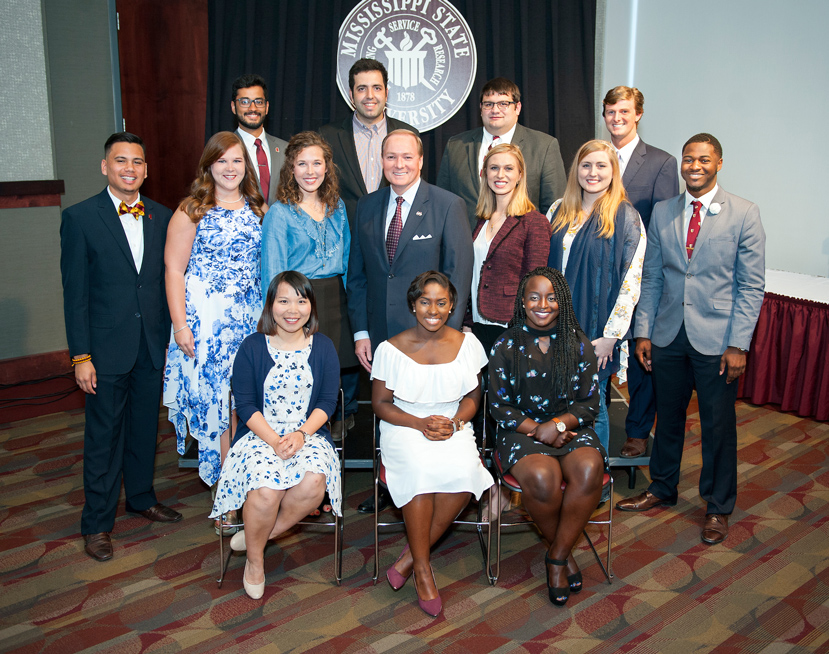 Pictured with MSU President Mark E. Keenum (middle row, center) are the 2017 Spirit of State honorees. They include (front, l-r) Jian Jiang, Shawanda Brooks, Terranecia Henderson (middle, l-r) Isaac Lias Jr., Caitlin Fournier, Shelby Williams, Roxanne Raven, Lauren Kiefer, Jeremy Knott (back, l-r) Mukhunth Raghavan, Roy Jafari, Alex Maxwell and Sam Andrews. Not pictured, Feifei Zeng also is an honoree. (Photo by Russ Houston)