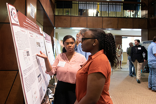 Jordan S. Bryant, an incoming freshman chemistry major from Porterville, speaks with a judge during Mississippi State’s Summer Undergraduate Research Symposium. For her research project titled “NIH R25 Bridges to Baccalaureate,” Bryant has been advised by Krish Krishnan, associate professor in the university’s Department of Biochemistry, Molecular Biology, Entomology and Plant Pathology. (Photo by Colleen McInnis)