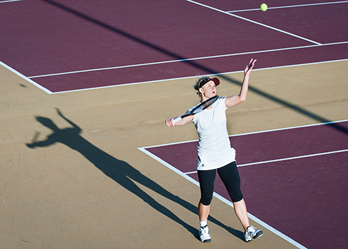 As the sun gets low, long shadows at the A.J. Pitts Tennis Centre are cast on the Bulldog serve. (Photo by Russ Houston, 2013)