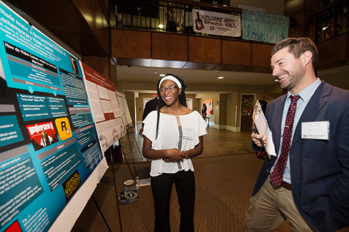 Junior biochemistry major Auriana P. Tucker of Brookhaven explains her research project “Grimms Tales Made Anew: A Benjaminian Analysis of Contemporary Video Games” to Assistant Professor of English Eric Vivier during Mississippi State University’s Spring Undergraduate Research Symposium. (Photo by Megan Bean)