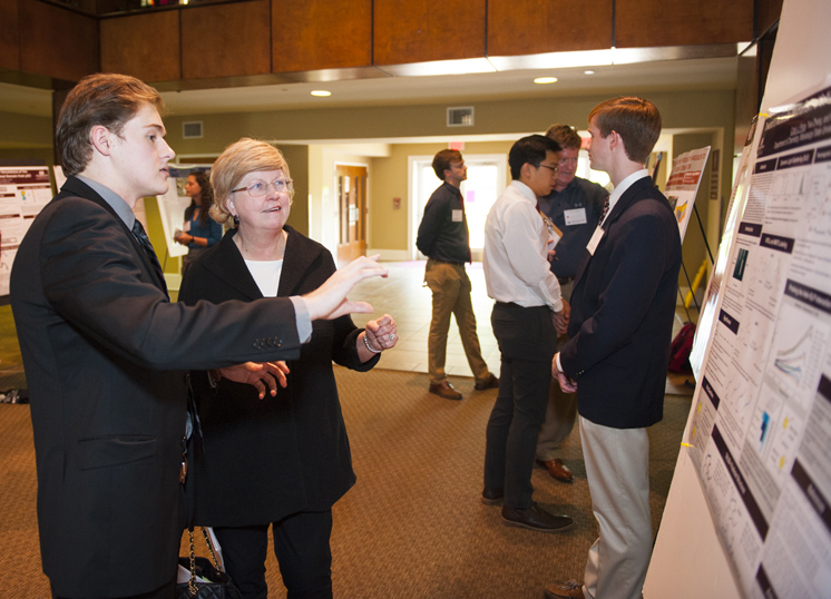 Cody J. Price of Houston, Texas, a senior chemistry major advised by MSU Assistant Professor of Chemistry Nick Fitzkee, shares his research project with MSU Provost and Executive Vice President Judy Bonner during the university’s Undergraduate Research Symposium. Titled “Toward a Molecular Mechanism of Self-Association in Elastin-Like Proteins,” Price’s project received a second-place award in the annual competition, of which Bonner’s office is a major sponsor. (Photo by Russ Houston)