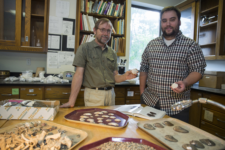 Evan Peacock, left, a veteran MSU anthropology professor, and Joseph A. Mitchell of Gautier, right, who soon graduates with a doctorate in earth and atmospheric sciences, are co-authors of a recent report in the American Malacological Bulletin describing the find of a winged mapleleaf mussel shell at a Leflore County archaeological site. Cliff Jenkins, not pictured, of the Natural Resources Conservation Service, also is a co-author. (Photo by Sarah Dutton)