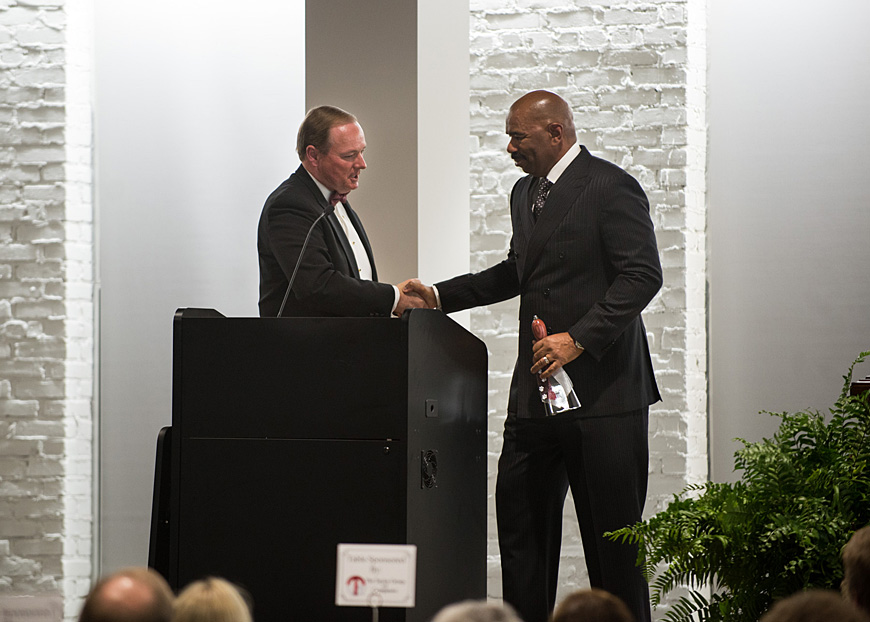 Mississippi State University President Mark E. Keenum presents comedian Steve Harvey with a cowbell Friday [Nov. 13] at the Mill at MSU Conference Center. Harvey served as keynote speaker for the College of Business Centennial Celebration Gala. (photo by Mitch Phillips)