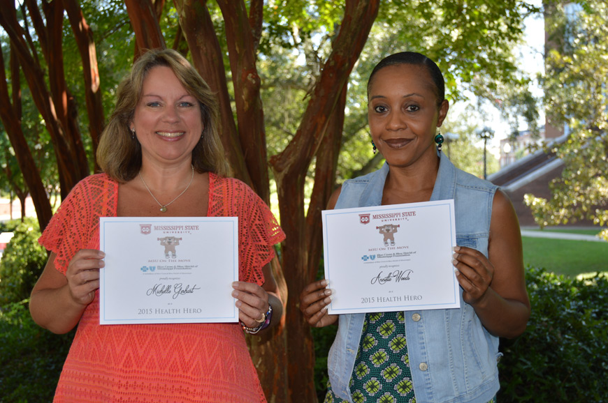 MSU on the Move Health Heroes Michelle Gerhart and Annette Woods receive certificates from the kinesiology department.