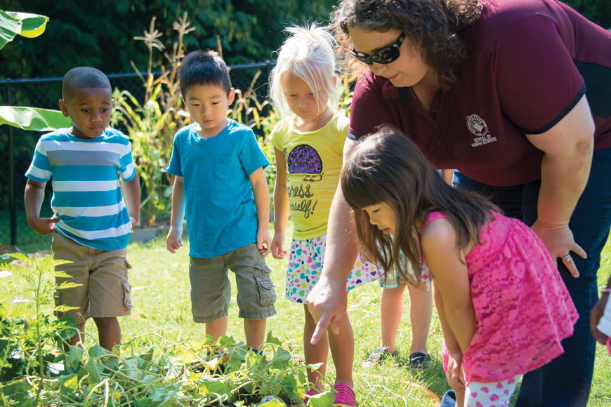 Lori Elmore-Staton identifies different vegetables in the garden at the MSU Child Development and Family Studies Center. (Photo by David Ammon)  