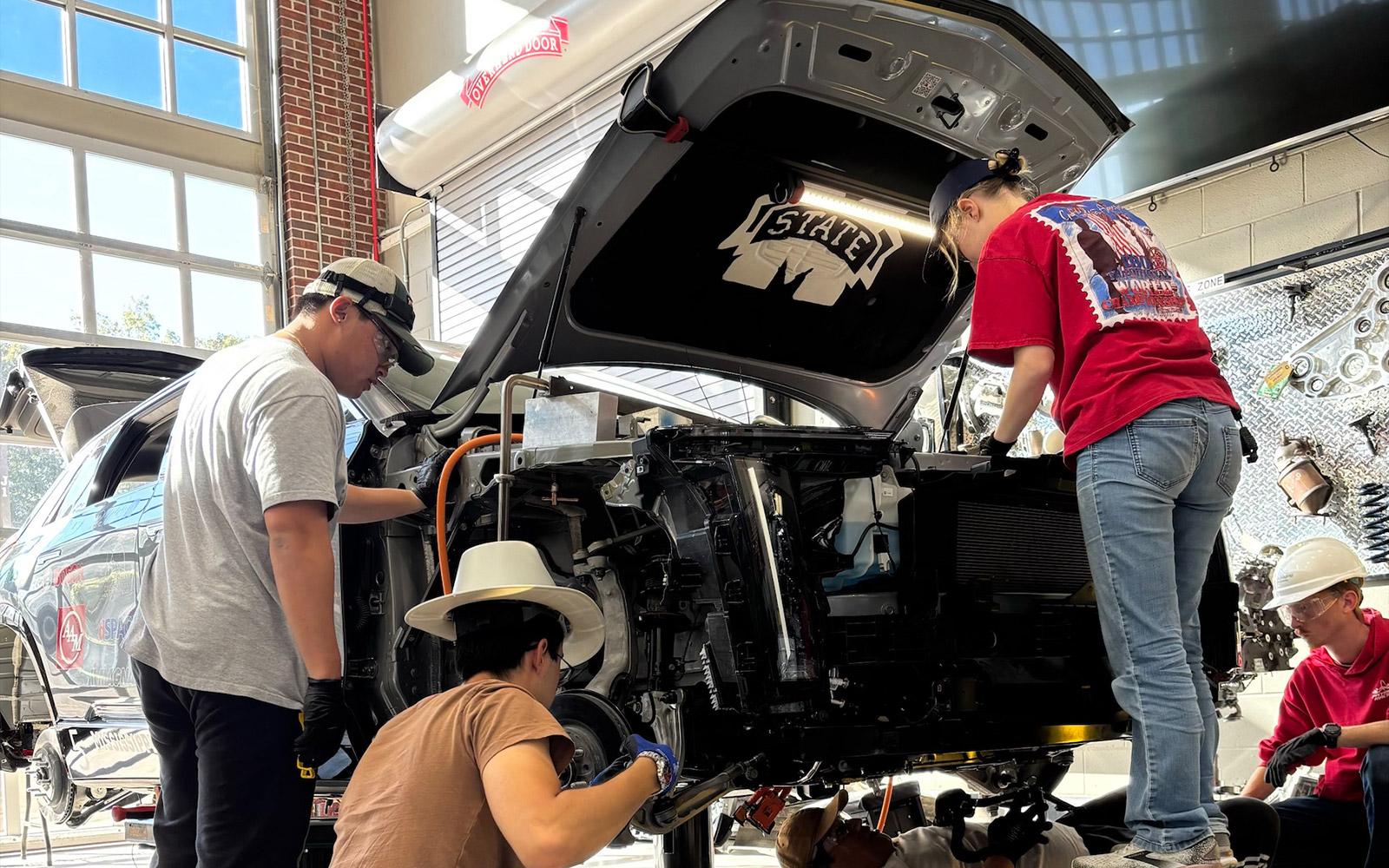 Mississippi State students working on a car