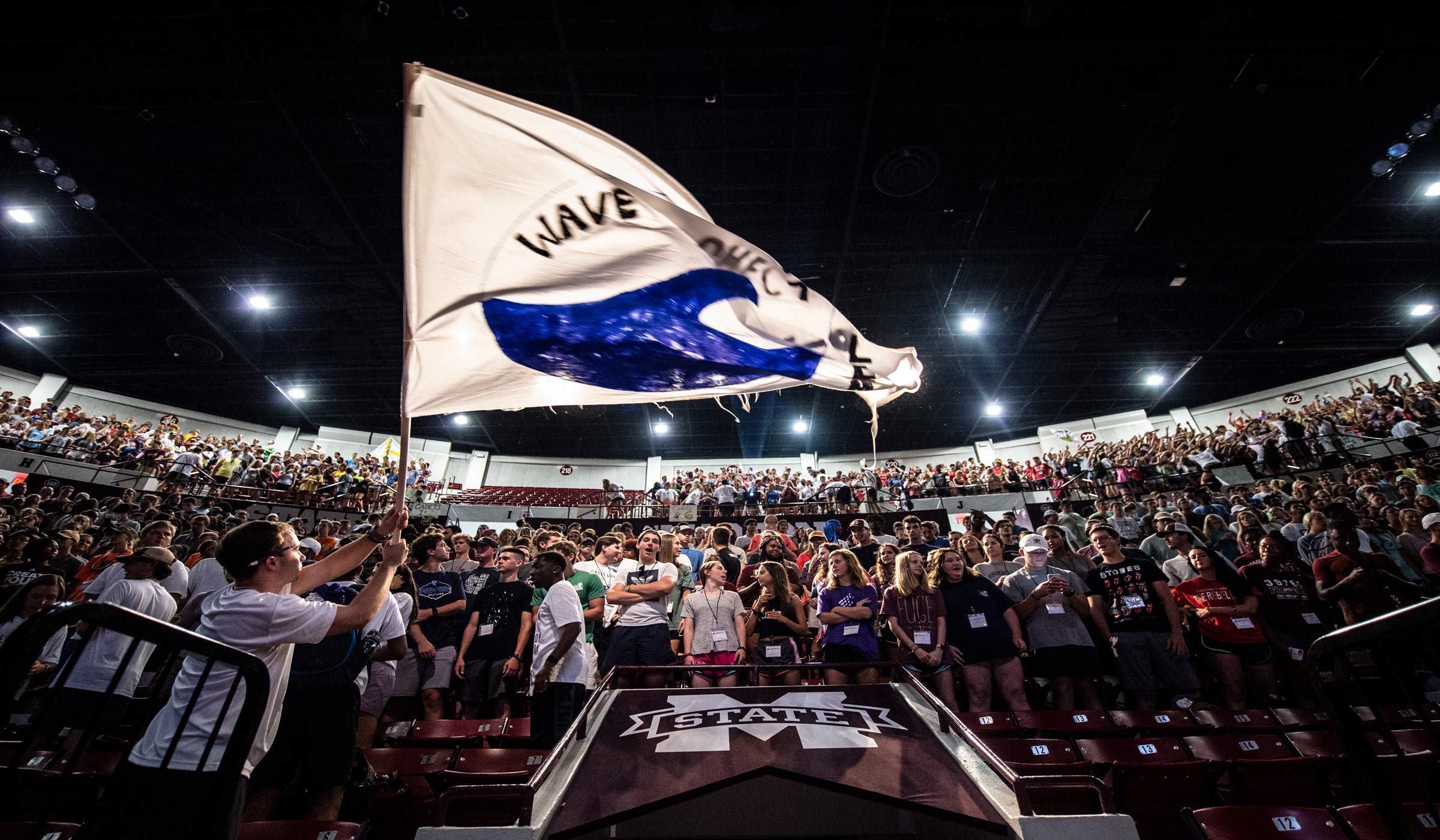 A flag representing a New Maroon Camp team is waved at the Hump during the welcome ceremony of the camp.
