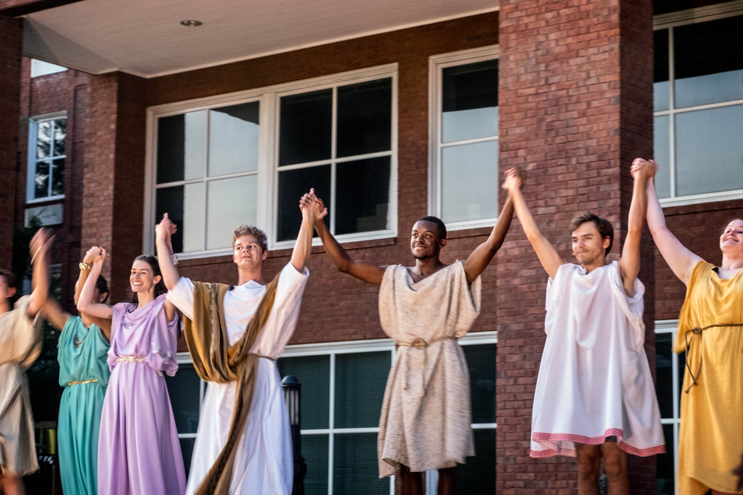 Dressed in togas for the Roman Comedy, the cast of the play takes a bow outside Griffis Hall.
