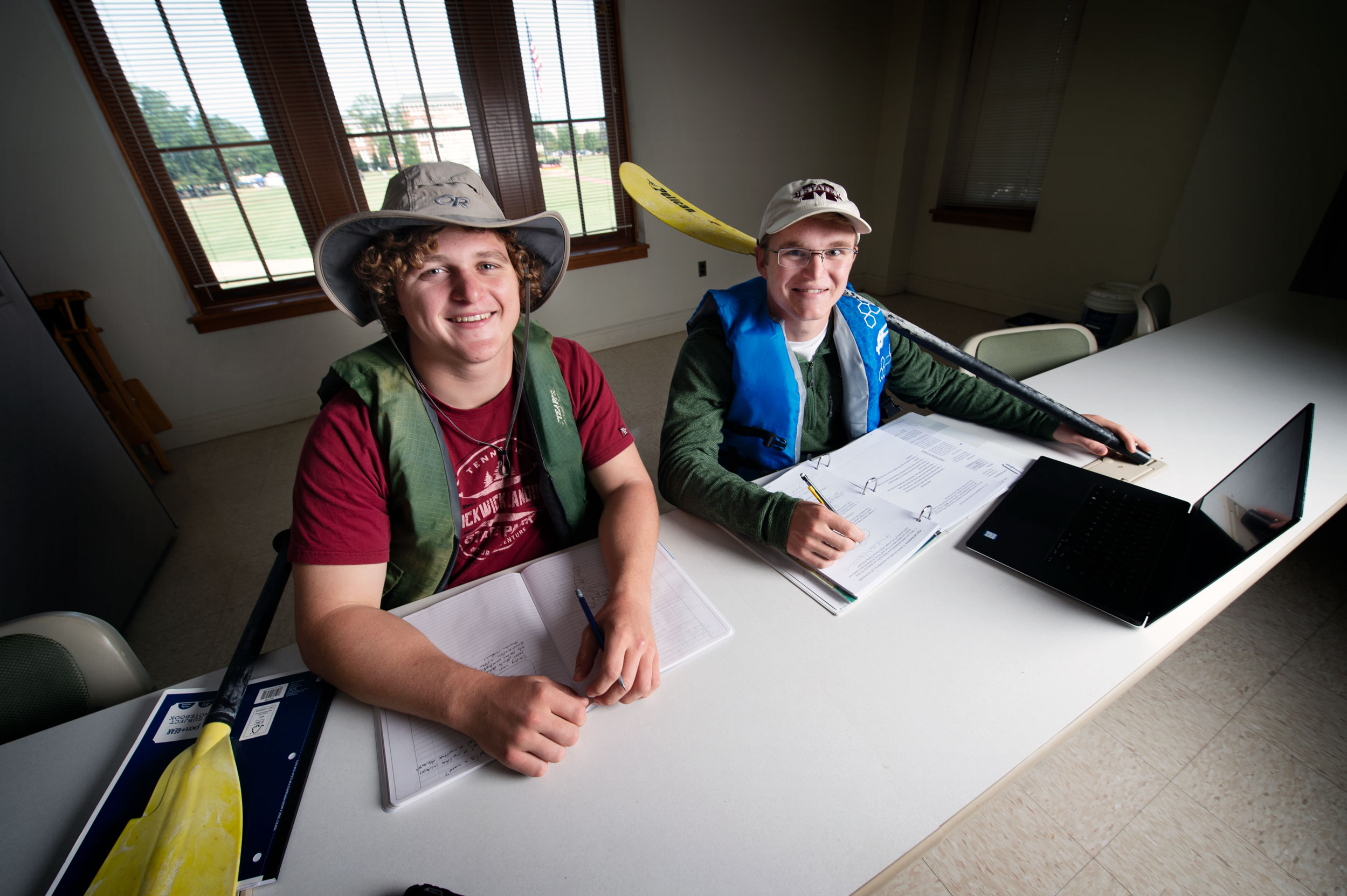 Jonah Albert and Luke Saulters, pictured in an MSU classroom wearing canoe gear.
