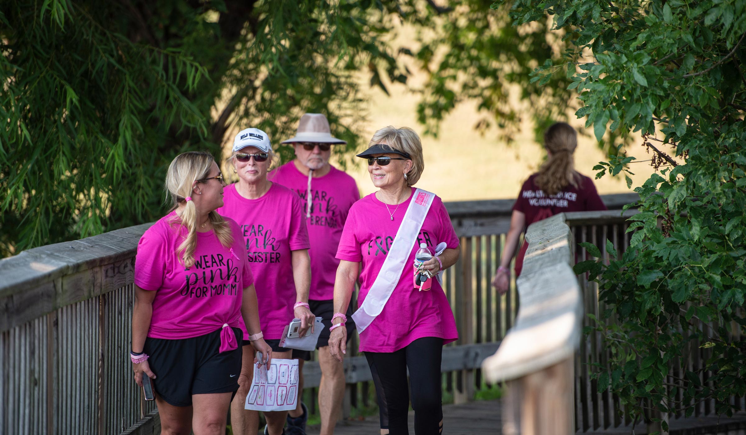 Breast Cancer survivors, friends and family walk around Chadwick Lake for the annual Pink Dog Walk for breast cancer awareness.